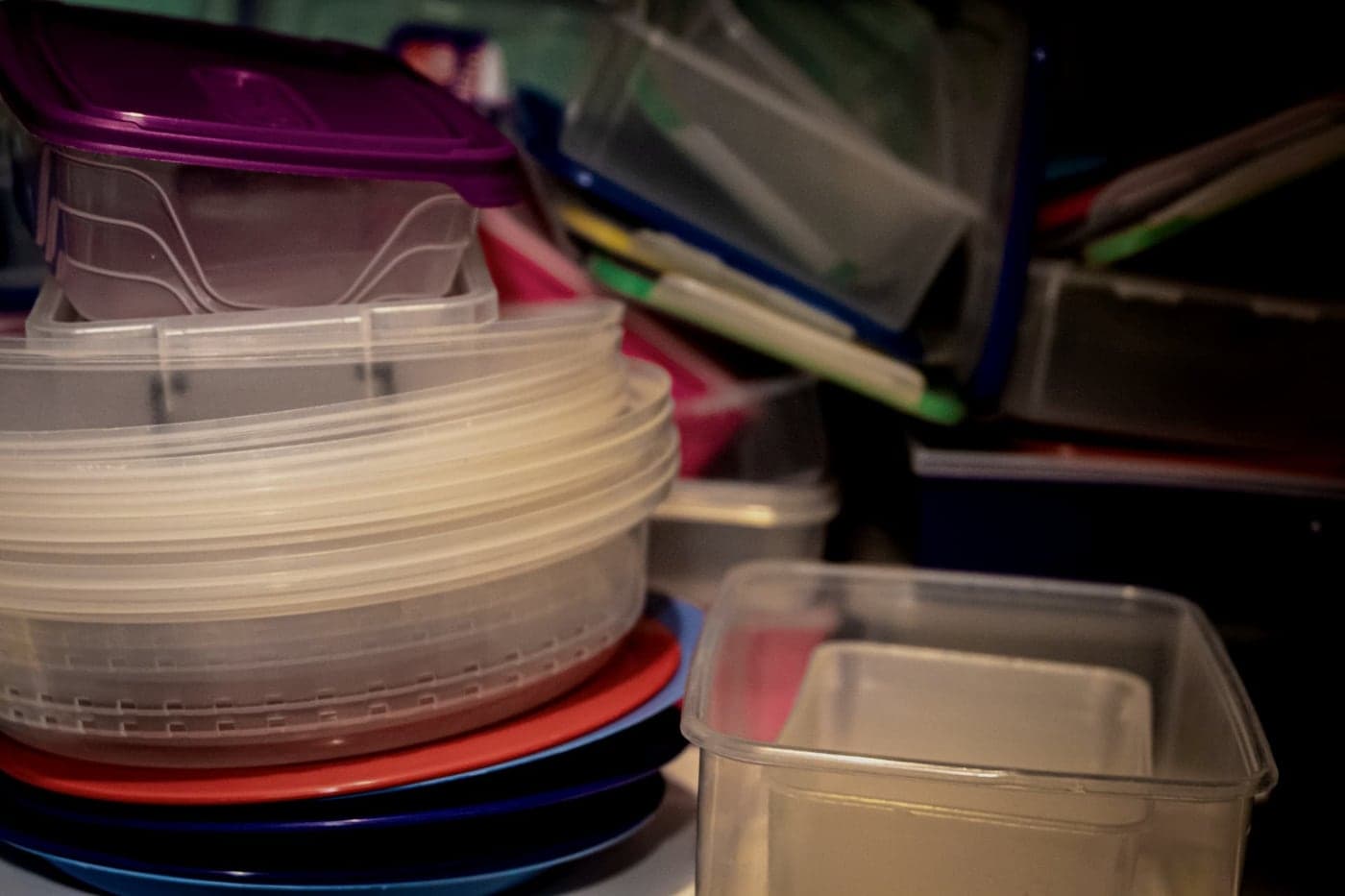 Plastic storage bins and containers stacked in a garage
