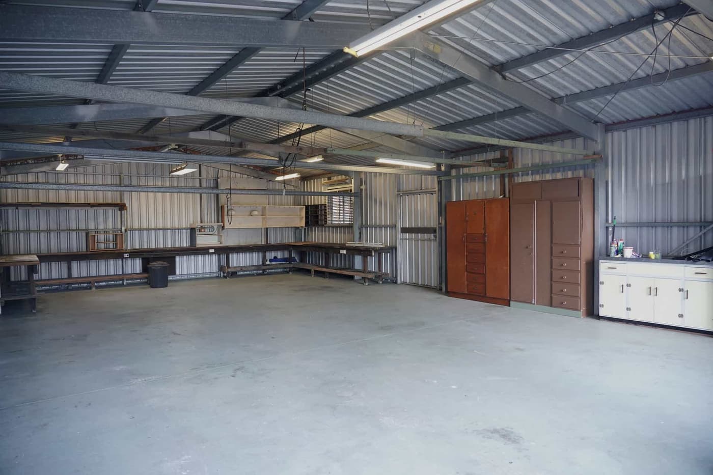 Garage storage cabinets and a workbench along a wall