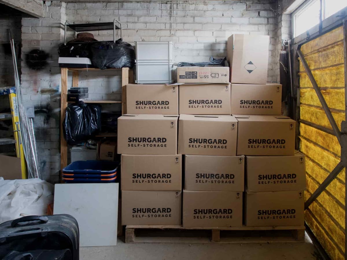 A stack of plastic storage totes in a garage