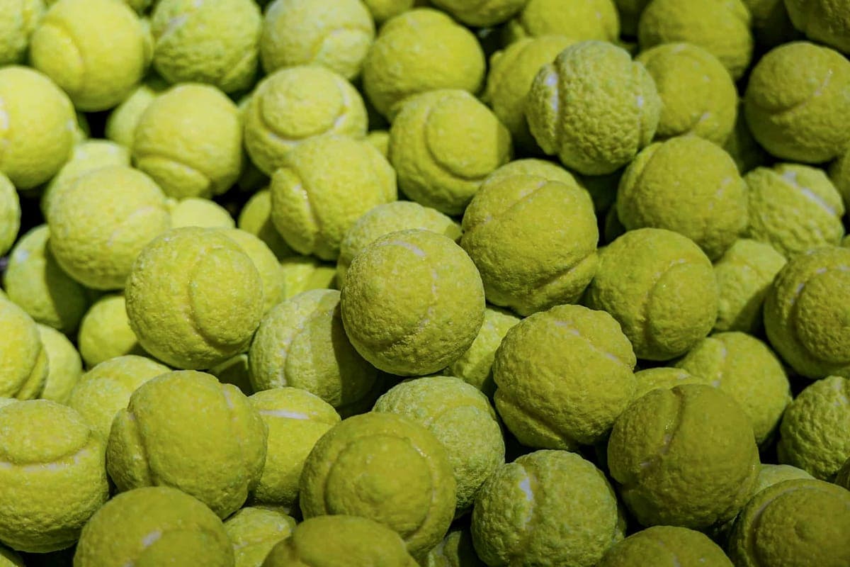 Assorted sports equipment and balls piled together