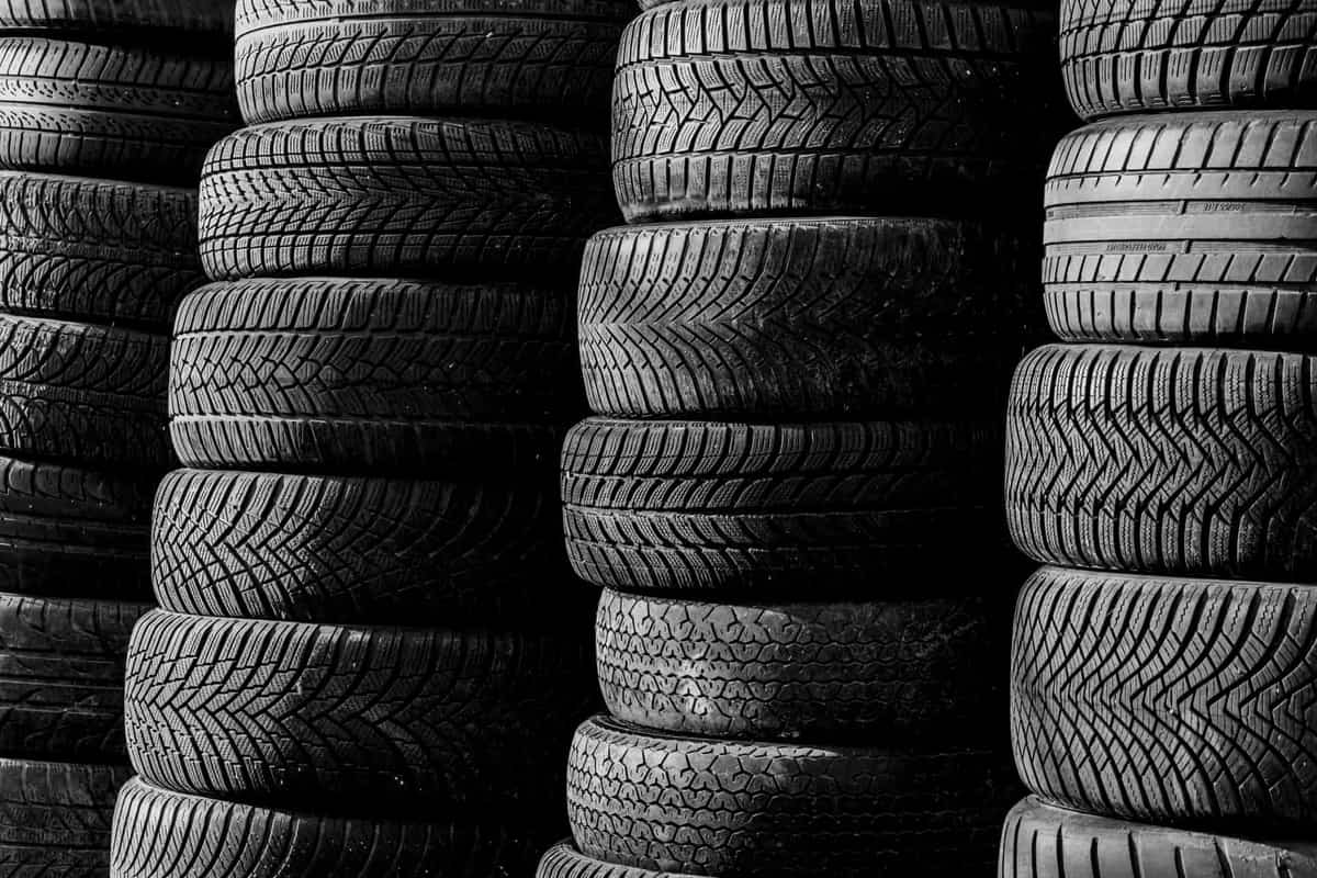 Car tires stacked on their sides in a garage